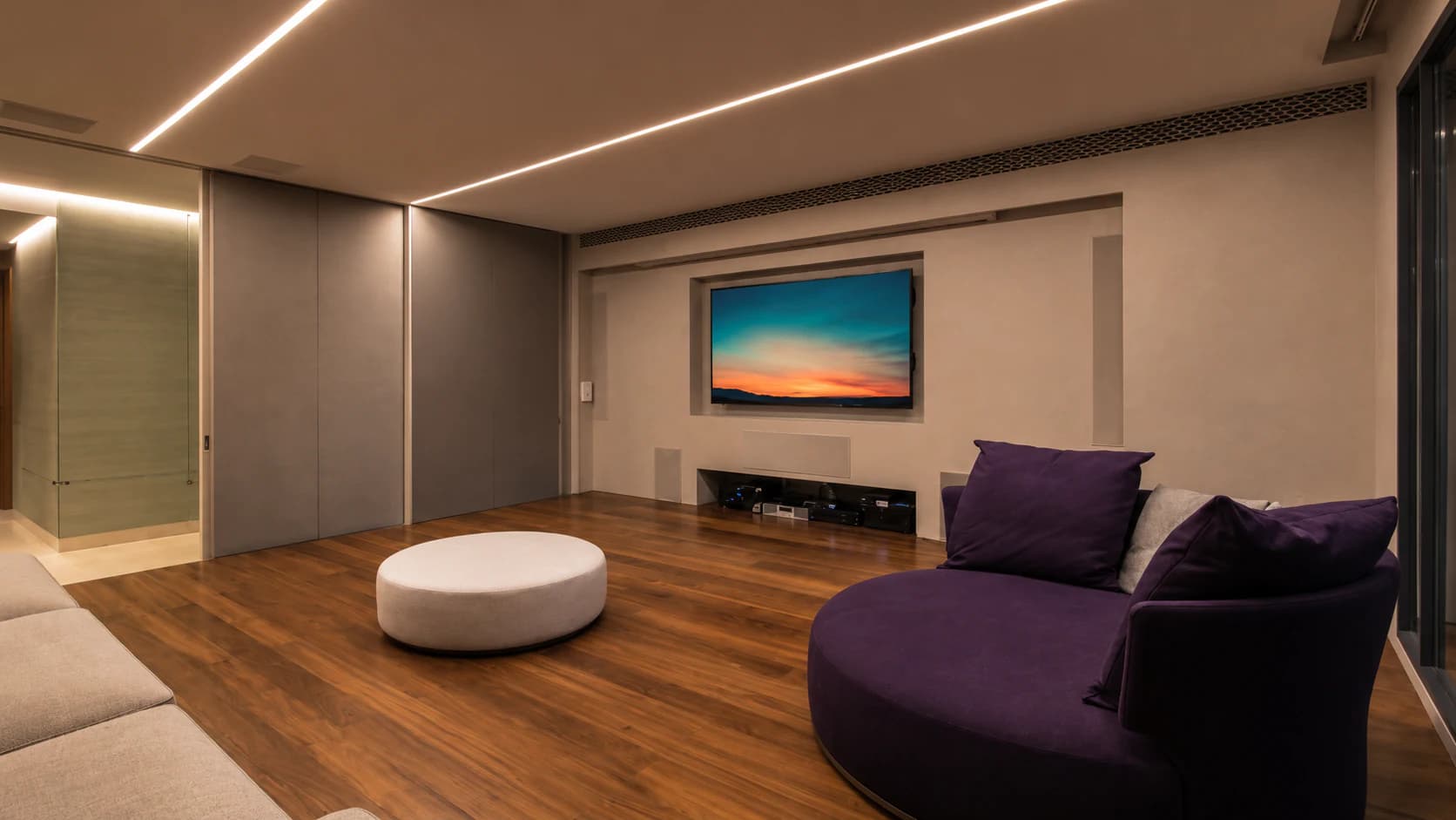 Completed integrated living space by Synchronos, with architectural lighting, concealed automation and finished interior work resolved as one environment.